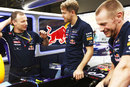 Sebastian Vettel chats with engineers in the Red Bull garage