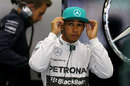Lewis Hamilton watches the action from the garage