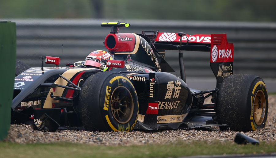 Pastor Maldonado sits in the gravel after putting his Lotus into the wall