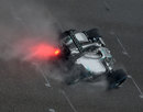 Lewis Hamilton drives through the wet in qualifying