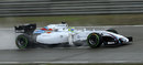 Felipe Massa drives through the spray in qualifying