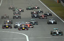 Lewis Hamilton leads down the pit straight as Felipe Massa makes contact with Fernando Alonso