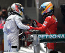 Fernando Alonso congratulates Lewis Hamilton on his victory in parc ferme