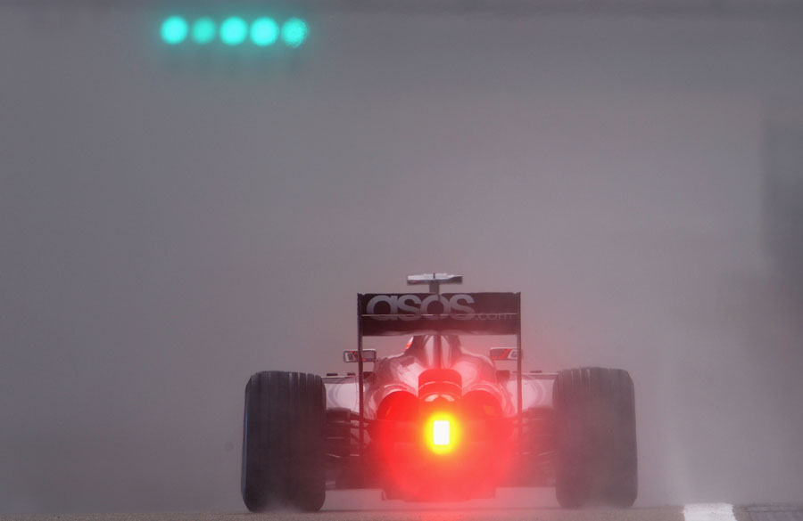 Jenson Button fights through the spray in final practice