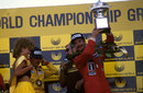 Nigel Mansell hoists the winners' trophy after his second successive victory