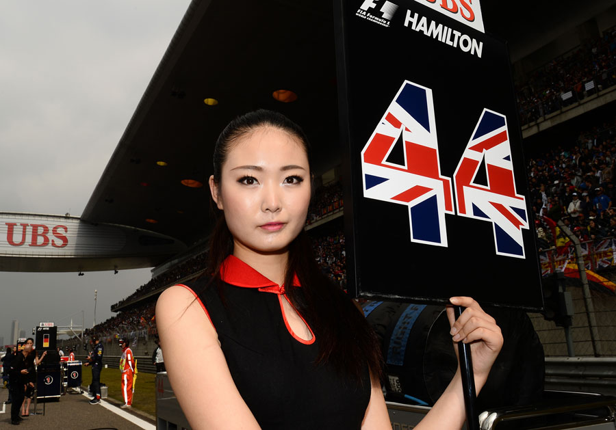 A grid girl stands in front of Lewis Hamilton's pole position