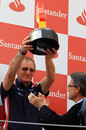 Williams race team manager Dickie Stanford lifts the winning constructors' trophy