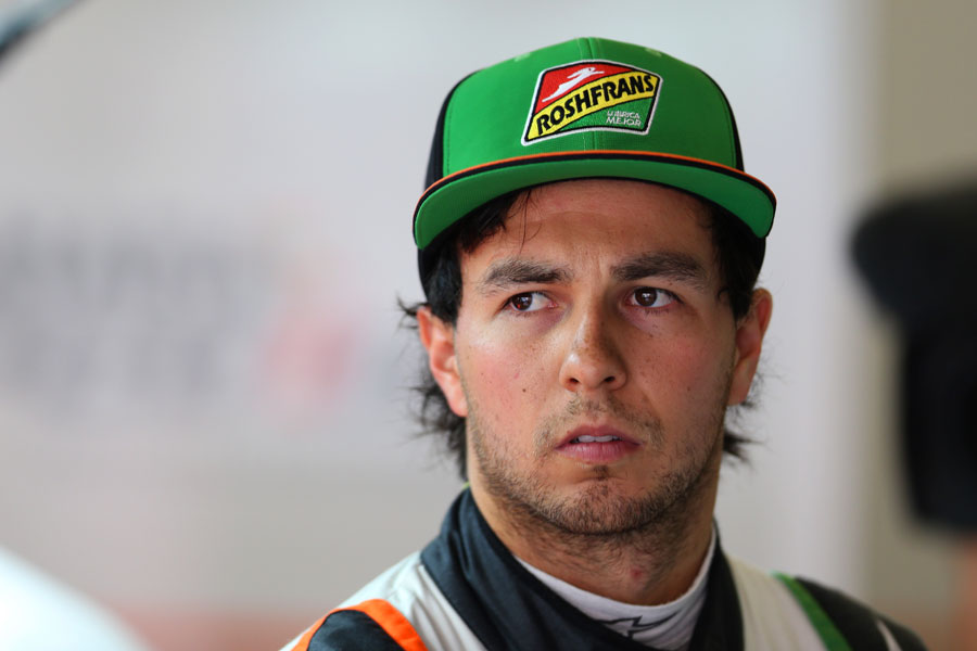 Sergio Perez looks on in the paddock
