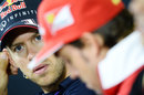 Sebastian Vettel talks to Fernando Alonso at the Thursday drivers' conference 