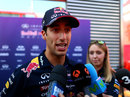 Daniel Ricciardo carrying out media duties in the paddock