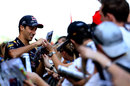 Daniel Ricciardo signs autographs in the paddock