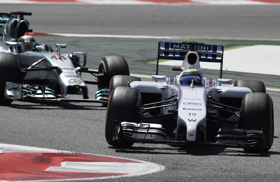 Williams driver Felipe Massa takes the corner ahead of Mercedes' Lewis Hamilton