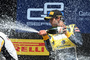 Felipe Nasr sprays champagne on the podium
