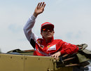 Kimi Raikkonen waves to the fans during the drivers' parade