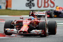 Fernando Alonso jumps his Ferrari over the kerbs