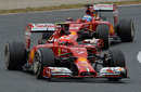 Kimi Raikkonen exits a corner with Fernando Alonso in close company