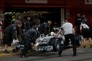 Lewis Hamilton gets wheeled back into the Mercedes garage