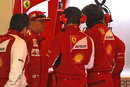 Kimi Raikkonen talks to his engineers after stopping on track