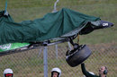 The remains of Kamui Kobayashi's Caterham is lifted away after he hit the barriers