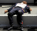 Sebastian Vettel takes a moment to relax in the sun