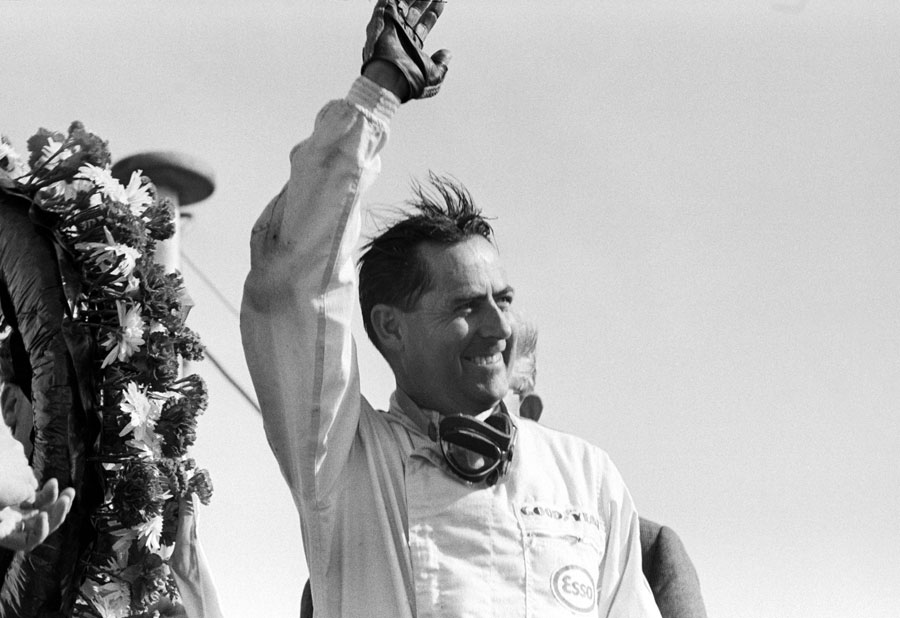Jack Brabham celebrates his third straight victory on the podium
