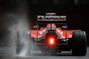 Fernando Alonso powers through the spray in the intermediate tyre in FP2