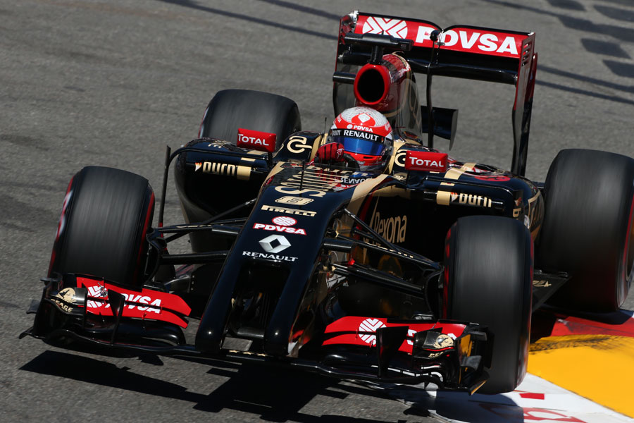Romain Grosjean bounces over a kerb on the supersofts