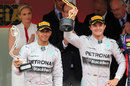 Lewis Hamilton and Nico Rosberg hold aloft their trophies on the podium