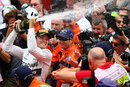 Nico Rosberg celebrates with champagne in parc ferme