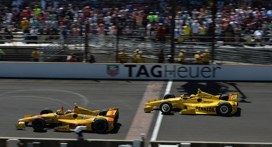Ryan Hunter-Reay raises his arm aloft in celebration after edging Helio Castroneves across the line in the Indy 500
