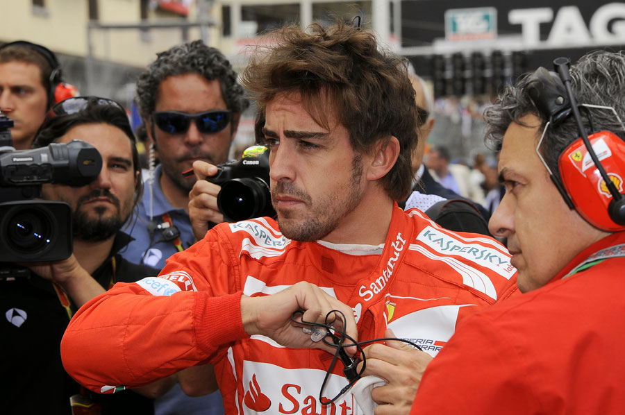 Fernando Alonso stands on the grid before the race