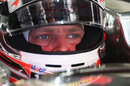 Kevin Magnussen sits in his car ahead of a practice run