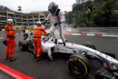 Valtteri Bottas climbs from his stricken Williams at the Loews Hairpin after an engine failure