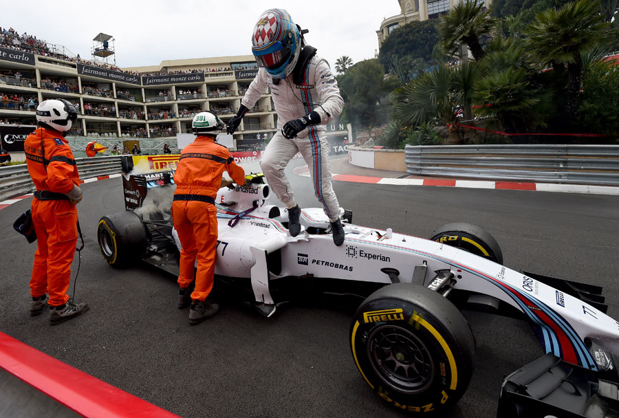 Valtteri Bottas climbs from his stricken Williams at the Loews Hairpin after an engine failure