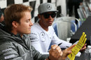 Title rivals and team-mates Nico Rosberg and Lewis Hamilton sign autographs