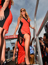 A grid girl arrives at the track ahead of the race