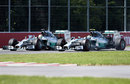 The fast-starting Lewis Hamilton gets alongside Nico Rosberg on the approach to Turn 1
