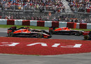 The Marussias of Max Chilton and Jules Bianchi head towards Turn 4, where they would collide and be forced to retire from the race