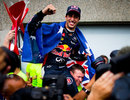 Daniel Ricciardo celebrates with the Red Bull team in the pit lane