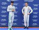 Nico Rosberg and Valtteri Bottas look on in parc ferme after both missed out on pole
