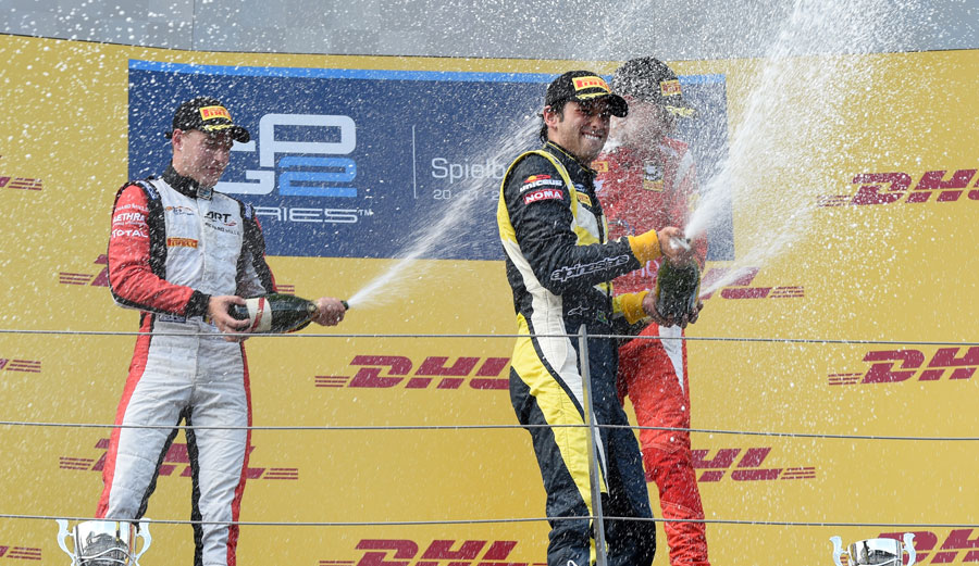 Felipe Nasr sprays champagne to celebrate victory, flanked by Stoffel Vandoorne and Raffaele Marciello