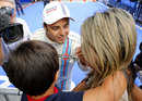 Felipe Massa celebrates with his wife and son after securing pole position