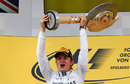 Nico Rosberg hoists aloft the trophy on the podium