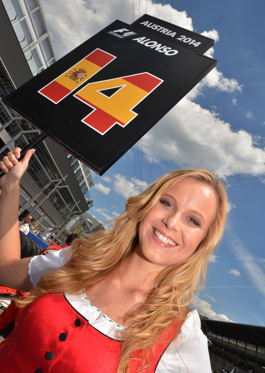 A grid girl stands poses for a picture before the start of the race