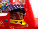 Fernando Alonso watches on from his cockpit in qualifying