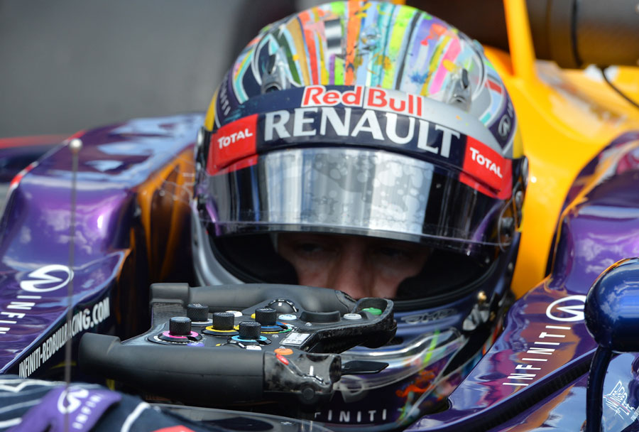 Sebastian Vettel removes his steering wheel after retiring in the pits