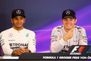 Lewis Hamilton and Nico Rosberg react to a question in the post-race conference