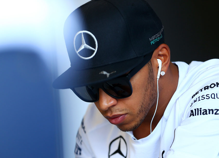 Lewis Hamilton sits by himself ahead of the drivers' parade
