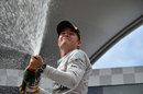 Nico Rosberg sprays champagne on the podium