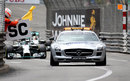Nico Rosberg and Lewis Hamilton follow the safety car up the hill